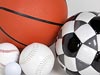 Basketball, soccer ball, softball, baseball and golf ball grouped on a white surface