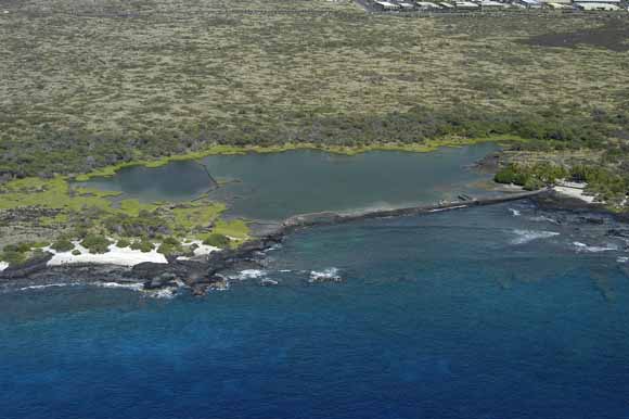 photo looking down on a coastal small embayment from a low-flying aircraft