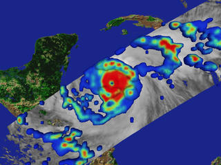 Precipitation rates on the ground superimposed on an infrared cloud image of Hurricane Mitch, measured by TRMM on October 27, 1998.  Red represents the regions of highest rainfall.