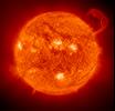 Extreme Ultraviolet Imaging Telescope (EIT) image of a huge, handle-shaped prominence taken on Sept. 14,1999 taken in the 304 angstrom wavelength - Prominences are huge clouds of relatively cool dense plasma suspended in the Sun's hot, thin corona.