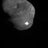 The image depicts the first moments after Deep Impact's probe interfaced with comet Tempel 1. The illuminated -- and possibly incandescent -- debris is expanding from the impact site.