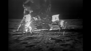 Partially restored video of Buzz Aldrin hammering a core sample tube into the moon's surface.