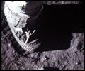 A close-up view of an astronaut's foot and foot print in the lunar soil