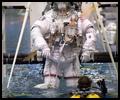 Expedition 12 crewmembers are about to be submerged in the waters of the Neutral Buoyancy Laboratory (NBL) near Johnson Space Center