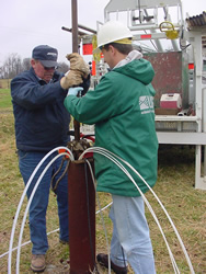 USGS and North Carolina Division of Environmental and Natural Resources scientists attaching a section of steel pipe to the BAT3 assembly at the Lake Wheeler Road Research Site, NC