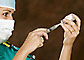 Doctor filling syringe