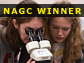 A male student and two female students gather by microscope in science lab.