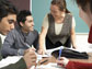 Photo of graduate students working at a classroom table.