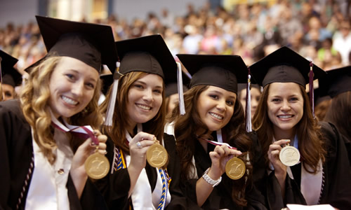 photo of TWU students in cap and gown during the graduation ceremony