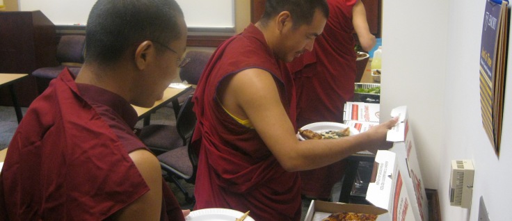 monks eating pizza