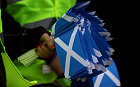 SNP activists carry flags while on the campaign trail on April 14, 2010 in Glasgow, Scotland