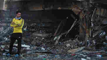 A young Iraqi on Thursday stands amid the debris of a double car bomb attack in Baghdad. There was no immediate claim of responsibility. President Obama's plan to attack Islamic State militants in Iraq and Syria will require help from partners on the ground in both countries.