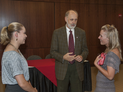 NIU President Doug Baker talks to new transfer students Alexis Massman and Lisa Matson