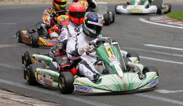 Formula One drivers Sebastian Vettel (front) and Michael Schumacher (behind) of Germany race go-carts