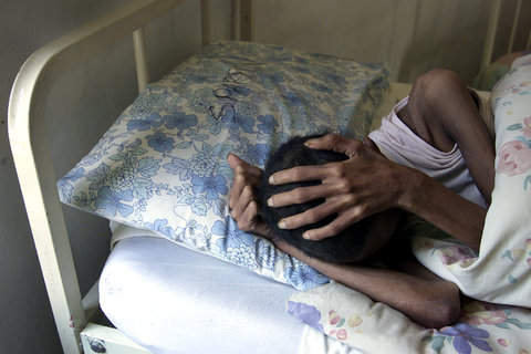 A female patient in her bed at the Sparrow Ministries' Rainbow Village. Dec. 20, 2002.