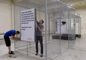 Crew members assemble the oversized rat cages central to Colorado Gov. John Hickenlooper's Don't Be a Lab Rat campaign. 