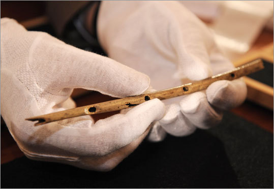 Professor Nicholas Conard of the University in Tuebingen shows a flute during a press conference in Tuebingen, southern Germany, on Wednesday.The thin bird-bone flute carved some 35,000 years ago and unearthed in a German cave is the oldest handcrafted musical instrument yet discovered.