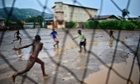 Boys play football in the rain in Freetown in Sierra Leone after the government cancelled classes because of the Ebola outbreak.