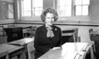 1982. Margaret Thatcher seated in the history classroom at her old school in Grantham.