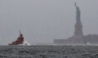 Waves crash over the bow of a tugboat as Hurricane Sandy approaches New York.