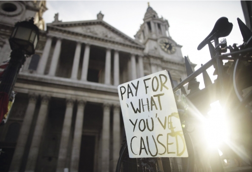 Pay up: a banner outside St Paul's Cathedral during the Occupy London protests. Photo: Rex/Matt Lloyd