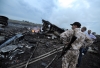 People stand next to the wreckages of the Malaysian airliner carrying 295 people from Amsterdam to Kuala Lumpur after it crashed, near the town of Shaktarsk, in rebel-held east Ukraine, on 17 July 2014. Photo: Getty Images