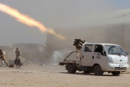 Iraqi Shiite militia fighters fire a rocket at Islamic State militant positions at Sayed Hassan village outside the city of Tikrit on Sep. 3, 2014