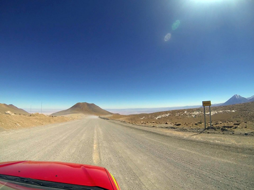 Shortly after taking this GoPro photo, Josh passed out as we descended from ALMA's high site, an expected physiological
         response to high altitudes. To the right, a sign reads "PELIGRO," which is "DANGER" in Spanish. Photo
         by Joshua Barajas/PBS NewsHour