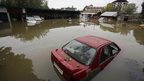 Vehicle are partially submerged in flood waters in Srinagar, India, Sunday, Sept.7, 2014