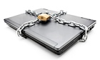 Heavy chain with a padlock around a laptop