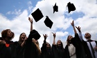 Students throw their hats in the air at their graduation ceremony