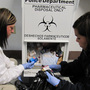 Layton, Utah police department employees Holly Plotnick and Shanae Perez pack discarded medications from a collection bin in the lobby in January 2010.