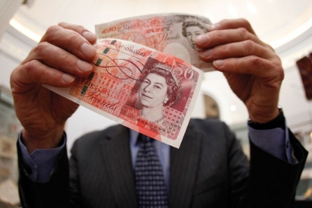 Man holding two fifty pound notes