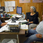 Vidal Saenz discusses farm operations with Catarina and Teofilo Flores Jr. in Edinburg. Saenz can help South Texas agricultural producers apply for direct emergency loans for farmers and ranchers who suffered drought losses in 2013. (AgriLife Communications photo by Rod Santa Ana)