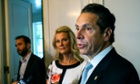 The New York governor, Andrew Cuomo, standing with his partner Sandra Lee, has retained the Democratic nomination for his post.