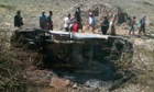 Yemenis surround a truck believed to have been hit by a US drone strike, killing 14 people, including 12 al-Qaida suspects, in the central province of Bayda,