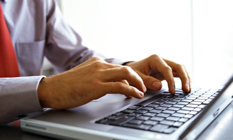 Man's hands on keyboard of laptop computer