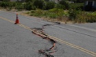 A cracked section of roadway is shown in the Carneros district of Napa, California, following an earthquake.