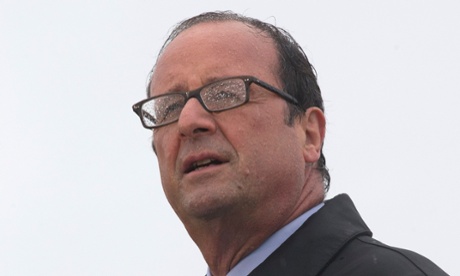 French President Francois Hollande delivers a speech in the rain on the Ile de Sein on August 25, 2014.