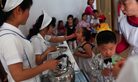 North Korean nurses give vitamin A supplements and deworming pills to children dressed in their best outfits at an elite nursery school in Pyongyang, North Korea.