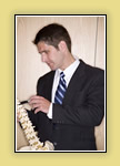 Male student examining spine model.