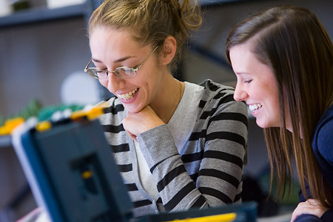 Two students smiling.