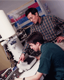 Photo of student and professor in physics laboratory