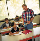 Photo of professor with smiling students in classroom