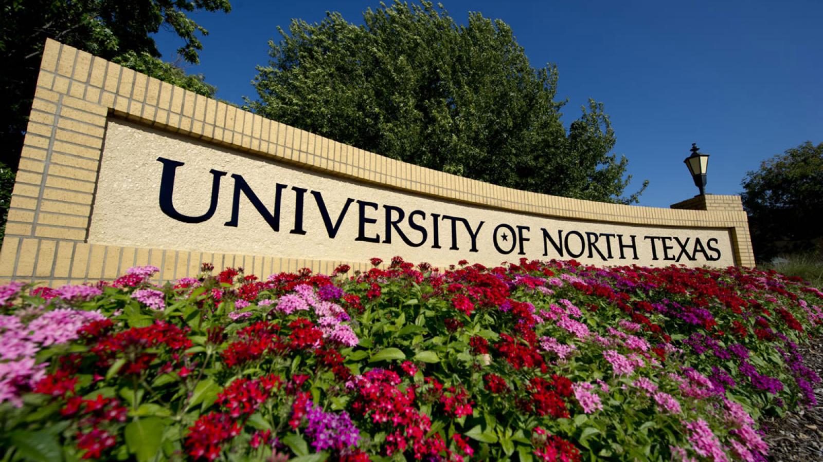 University of North Texas sign with flowers
