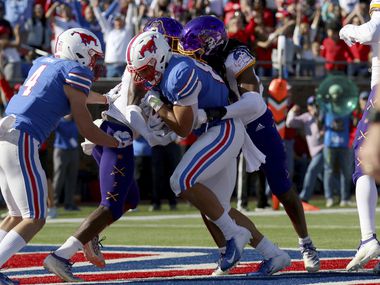 SMU tight end Kylen Granson, center, scores a touchdown while wide receiver Tyler Page (4) looks on during the second half of an NCAA college football game, Saturday, Nov. 9, 2019, in Dallas. (AP Photo/Roger Steinman)