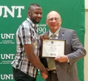 DaMiri Young pictured shaking hands with UNT Vice President Bob Brown