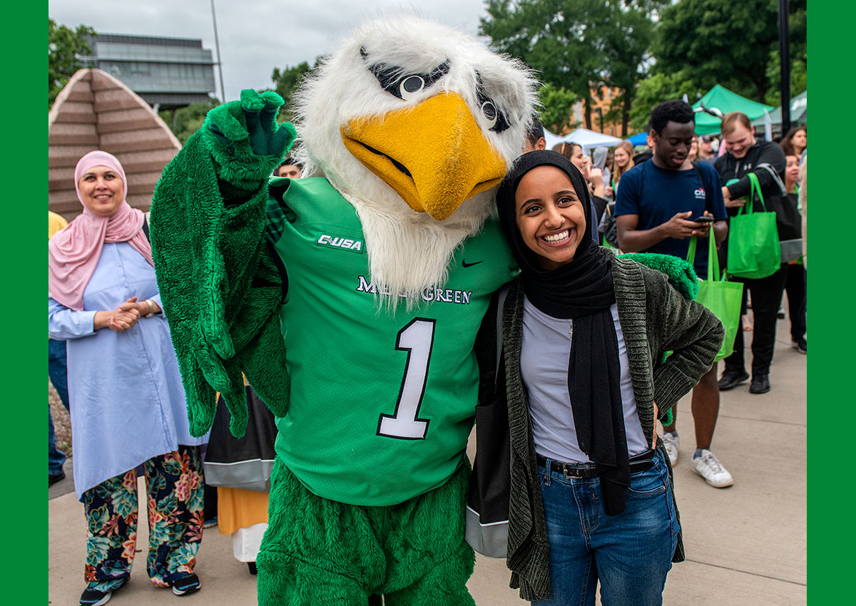 Student posing for picture with Scrappy at 2019 Block Party