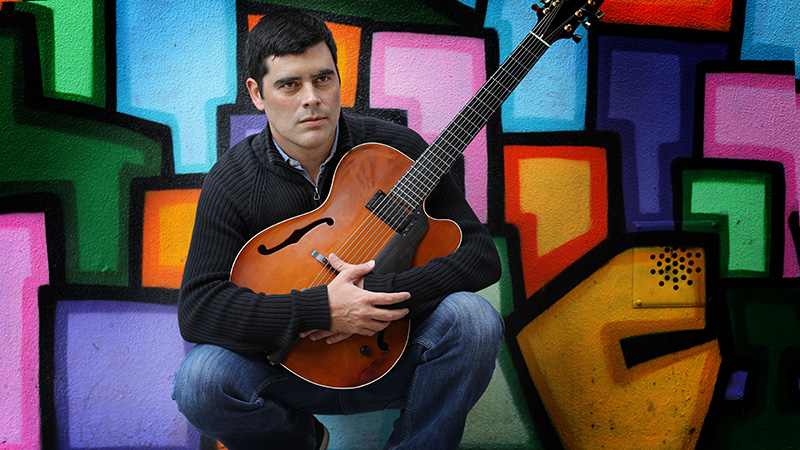 Davy Mooney, with guitar