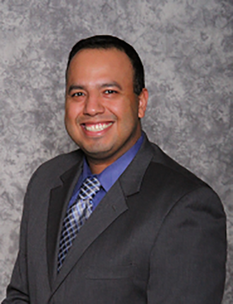 David Saenz in front of a grey background